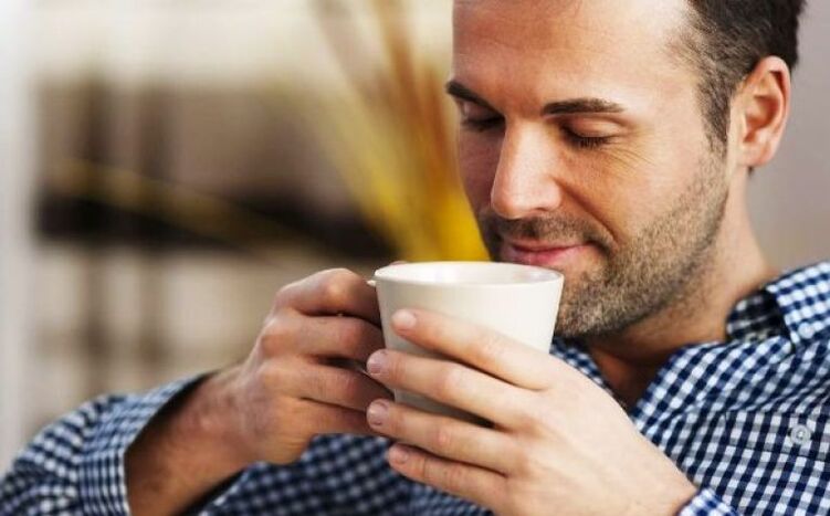 A man drinks a cup of tea to increase his potency